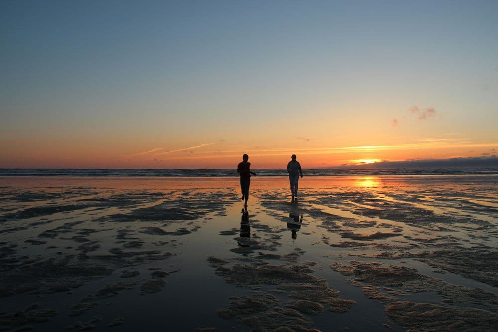 Couple running on Grayland Beach